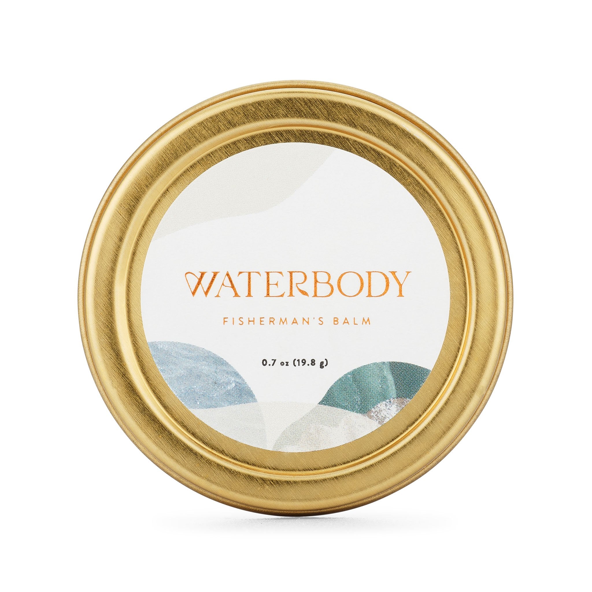 A golden tin of Fisherman's Balm sits agains a white backdrop. The tin features a white round label with blue and green imagery and gold foil text